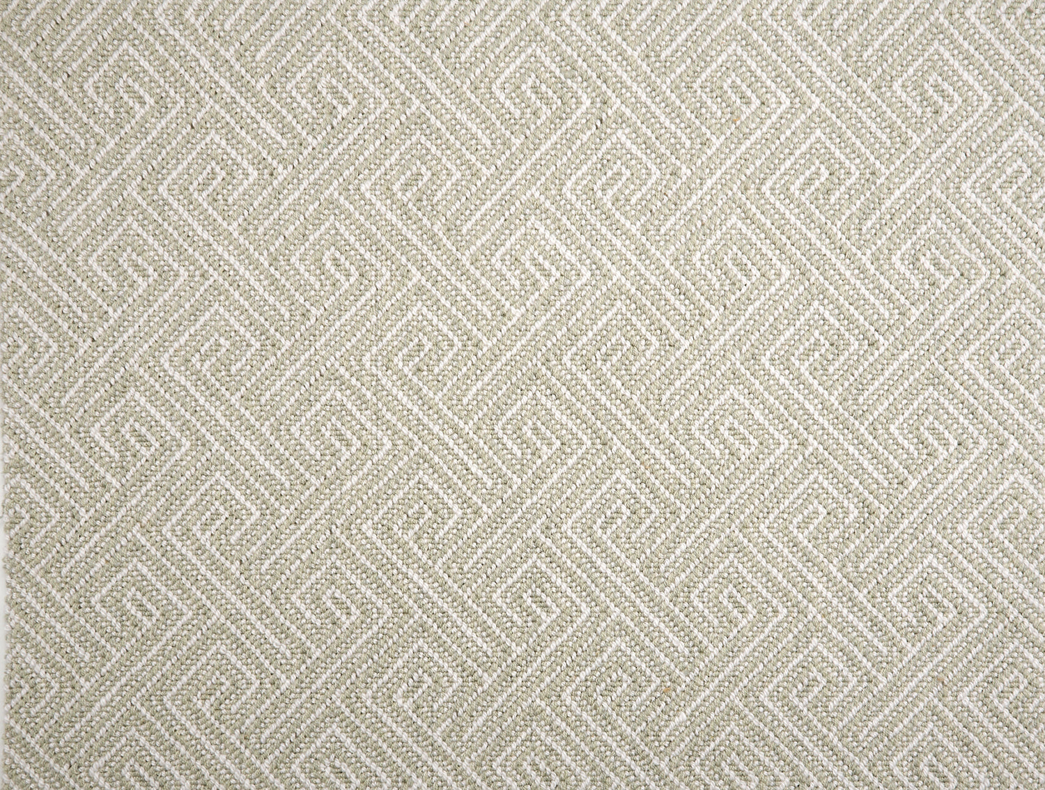 Broadloom carpet with Greek key pattern in cream on grey-green.