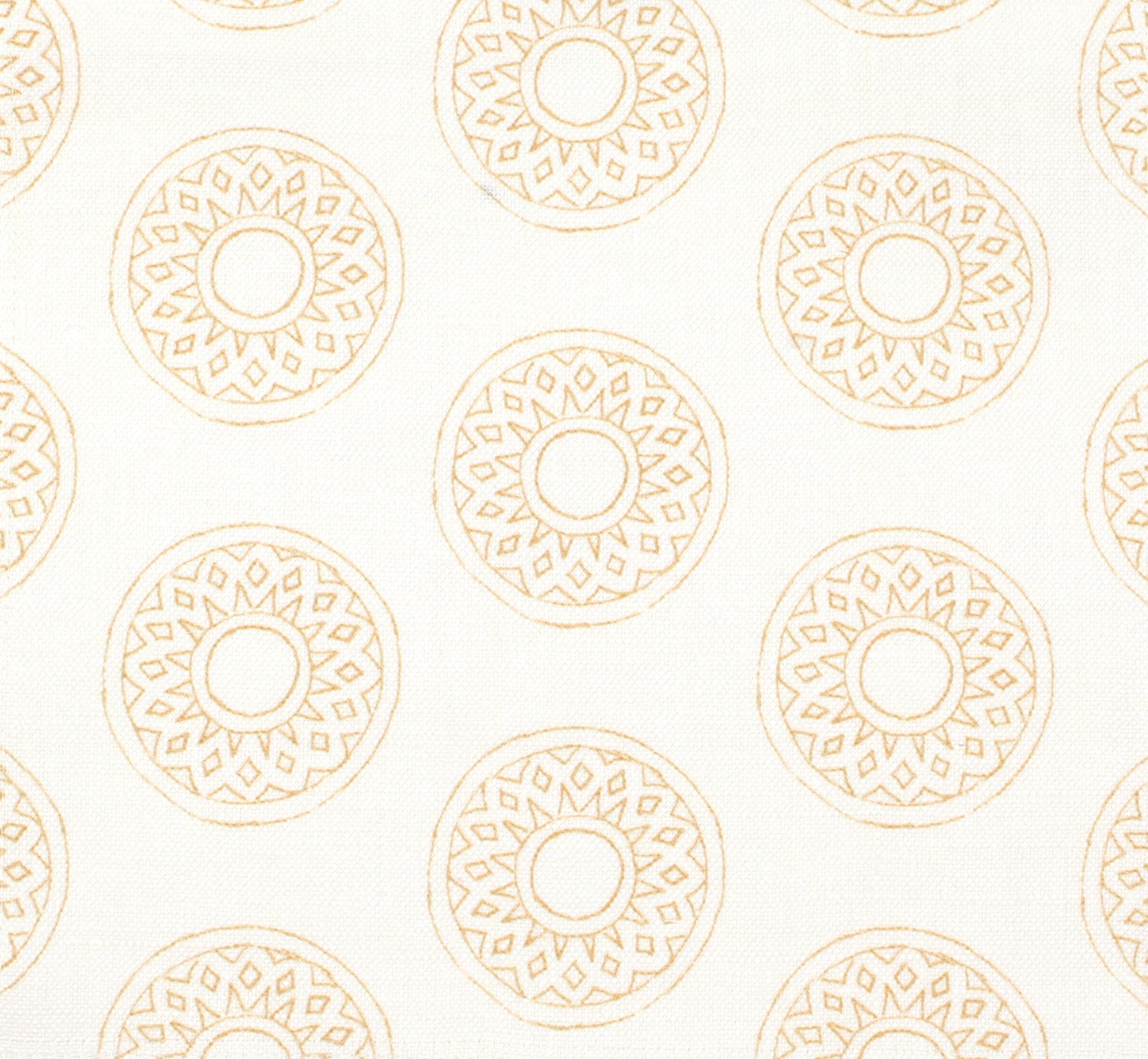 Detail of fabric in a repeating circular geometric print in yellow on a white field.