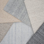 Close-up of various textured gray and beige carpet samples.