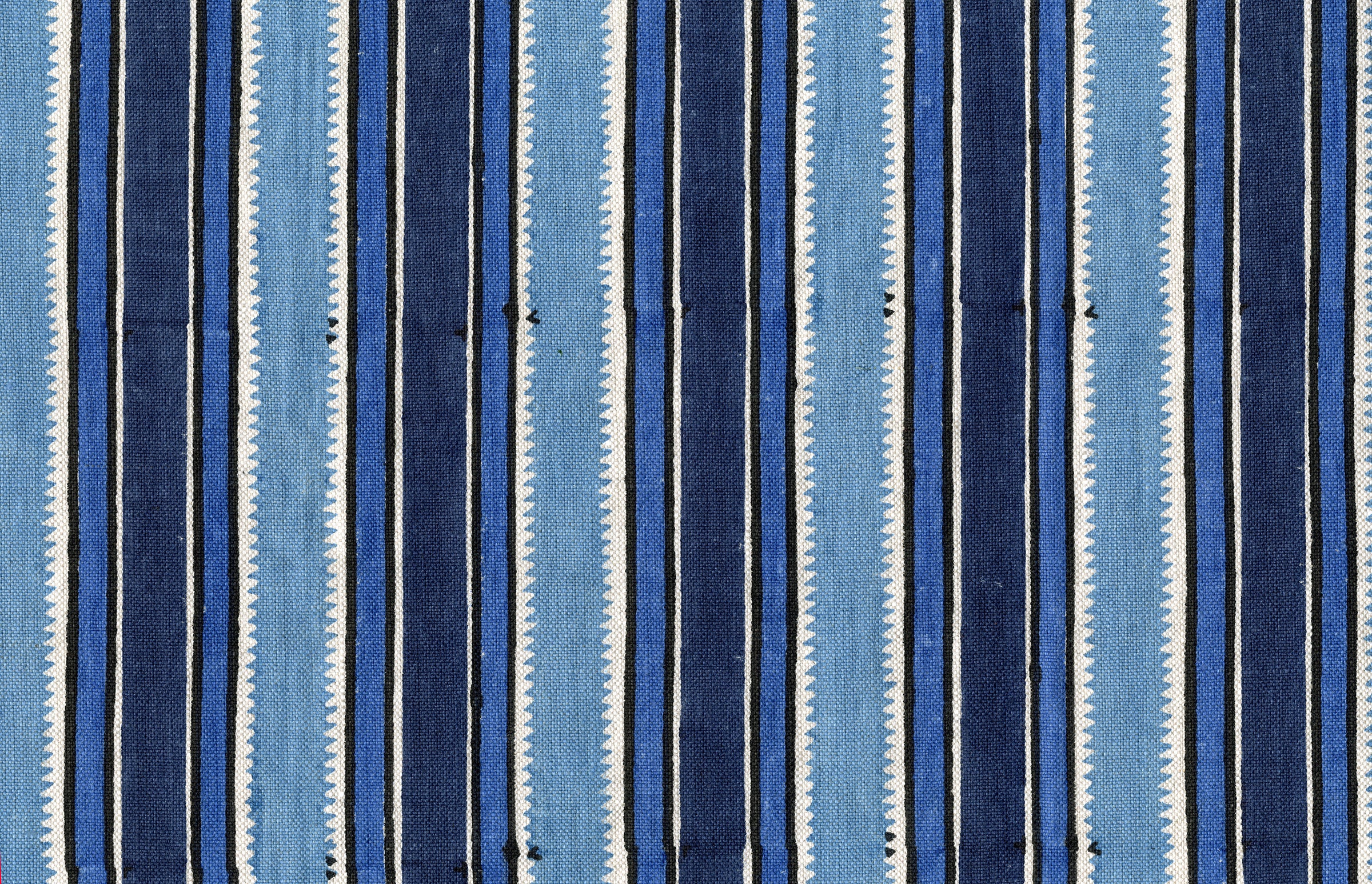 Fabric in a playful irregular stripe pattern in shades of blue, navy and cream.