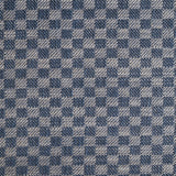 Close up of woven fabric with small scale checkerboard pattern in white and navy blue. 