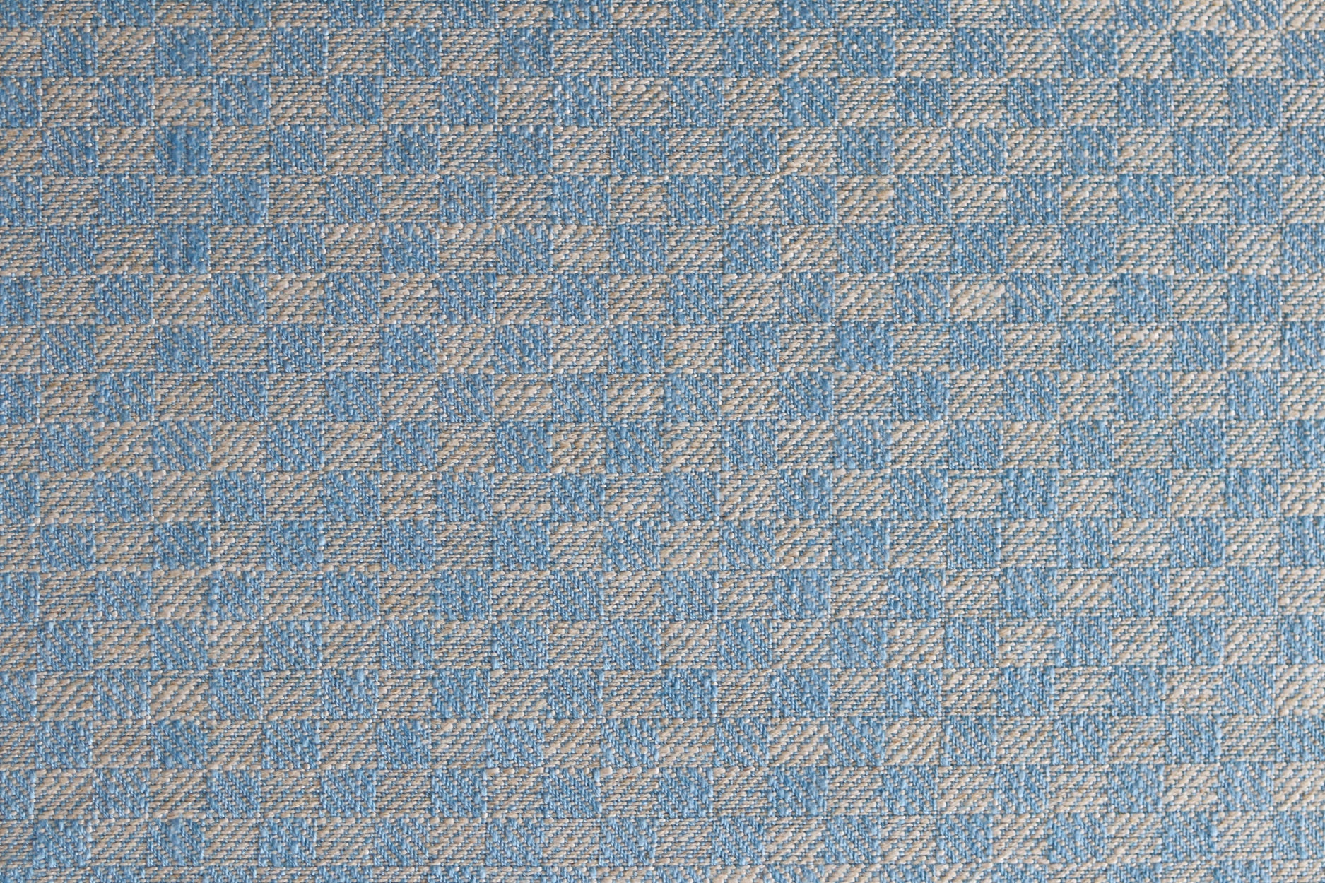 Close up of woven fabric with small scale checkerboard pattern in white and sky blue. 