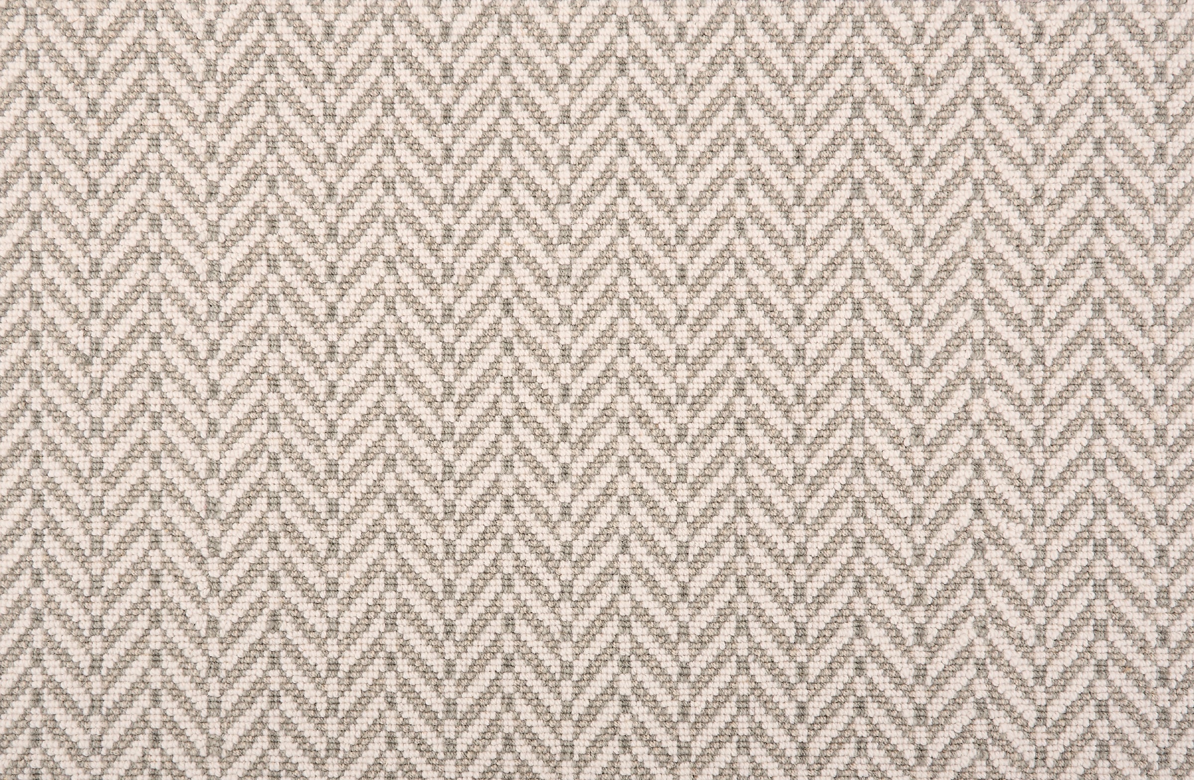 Broadloom carpet in a herringbone pattern grey and white. 