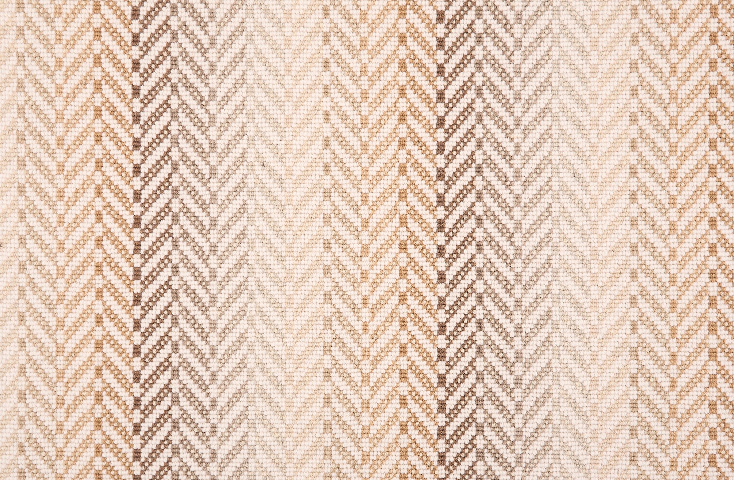 Broadloom carpet in a herringbone pattern with ombré stripe design in shades of brown with white. 