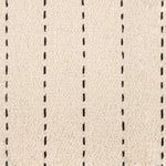 Broadloom carpet with a thin dashed stripe in black leather on a cream field.