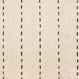 Broadloom carpet with a thin dashed stripe in black leather on a cream field.