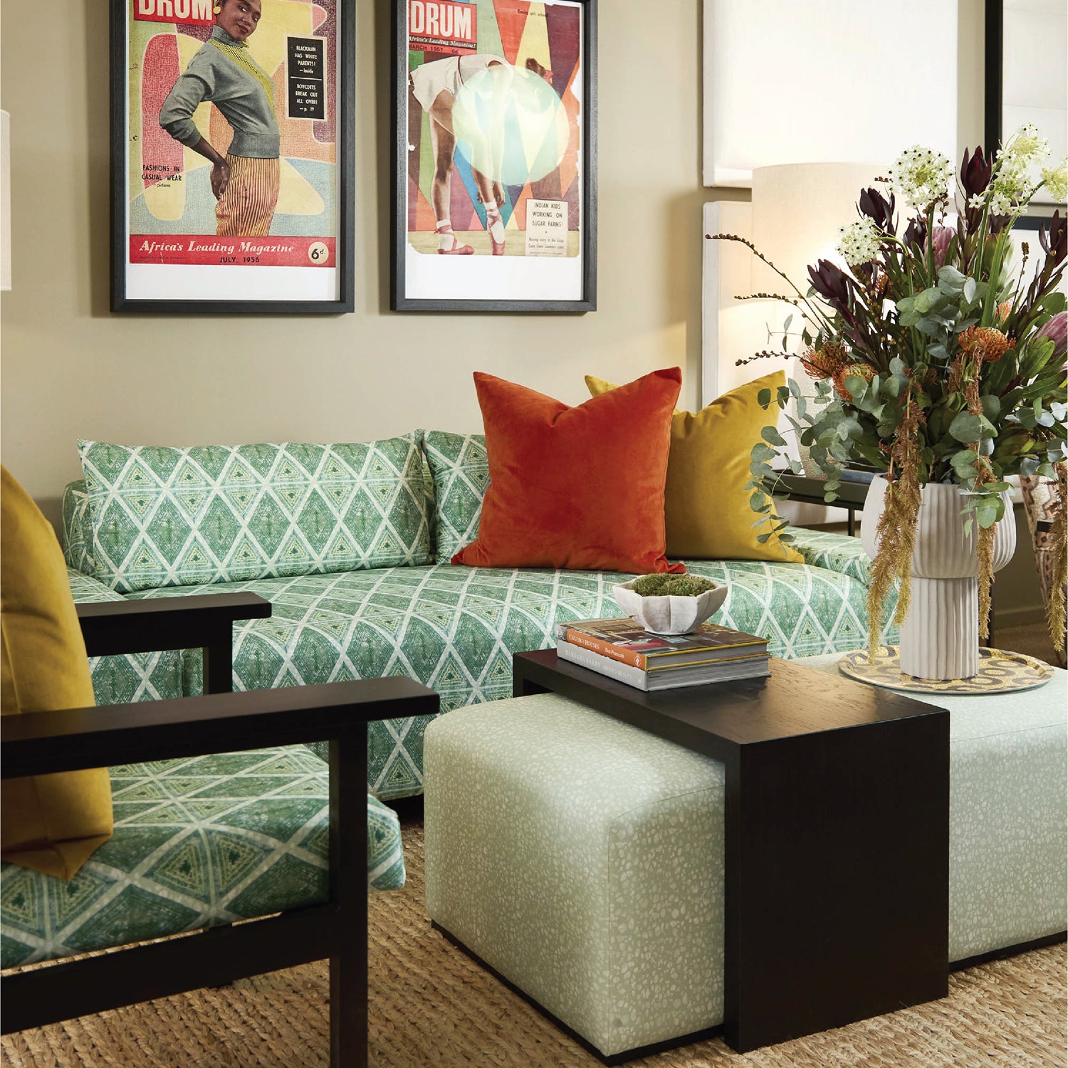 Living room with a green patterned sofa, colorful pillows, and decorative items.