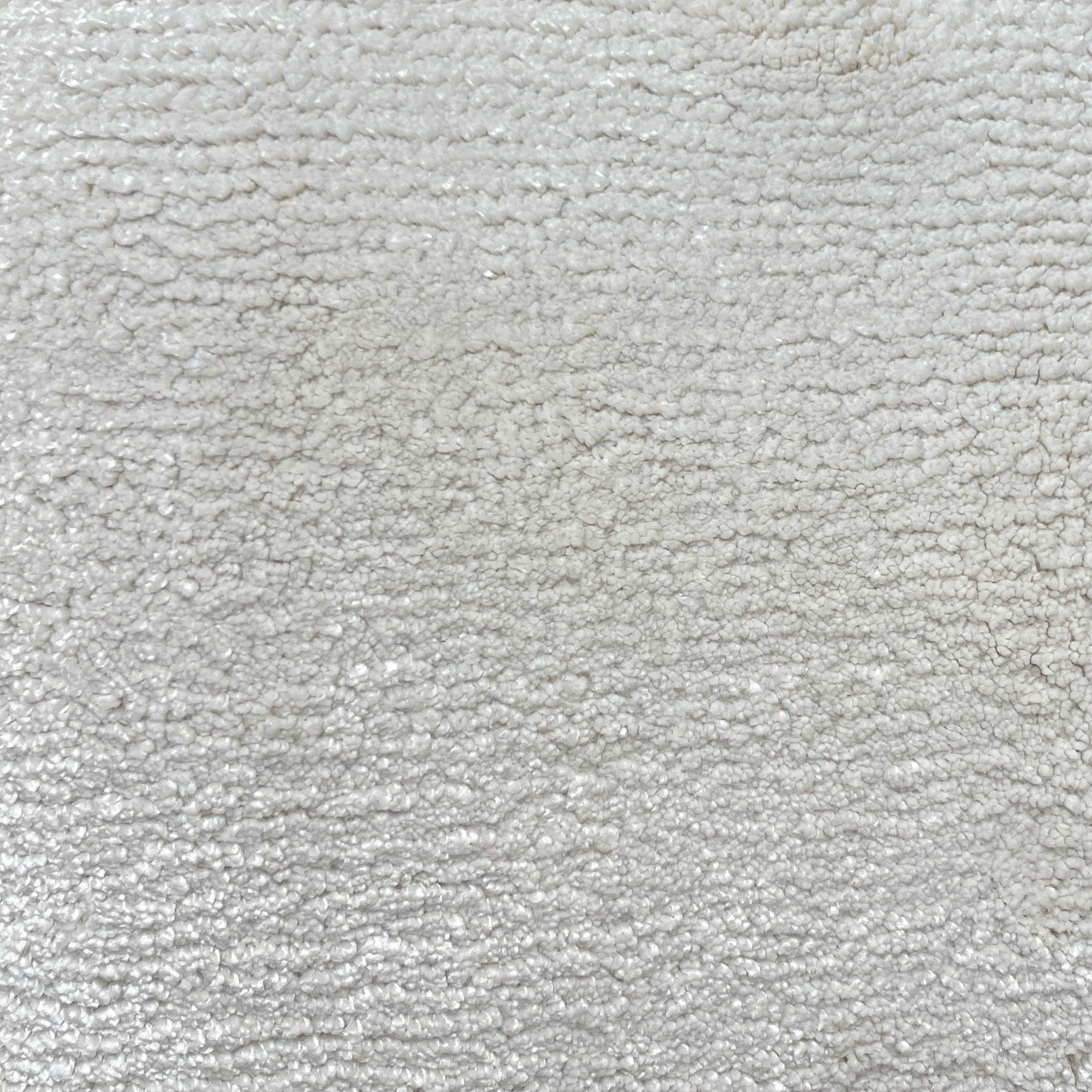 Broadloom carpet in cut pile in cool white. 