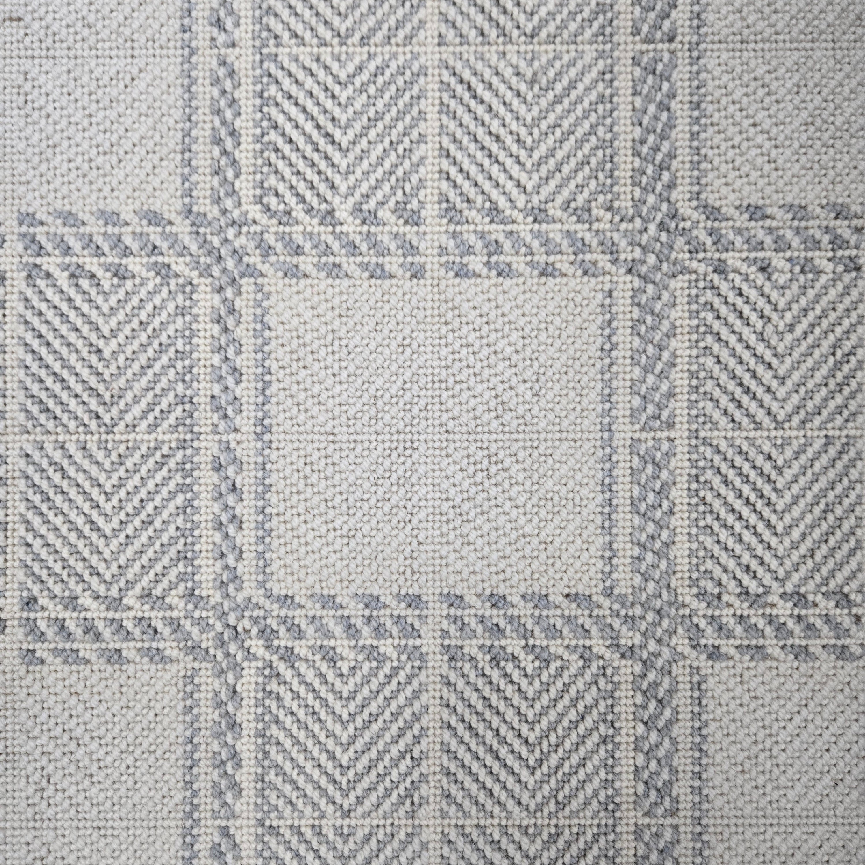Broadloom carpet in wide box checkerboard pattern in cream and light blue.