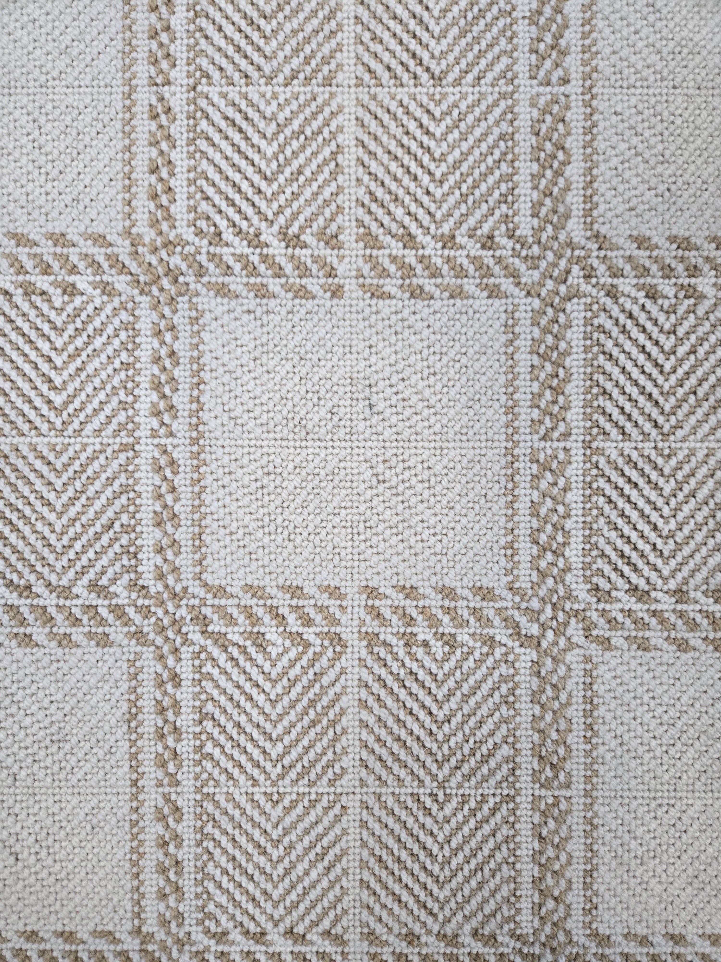 Broadloom carpet in wide box checkerboard pattern in cream and tan.