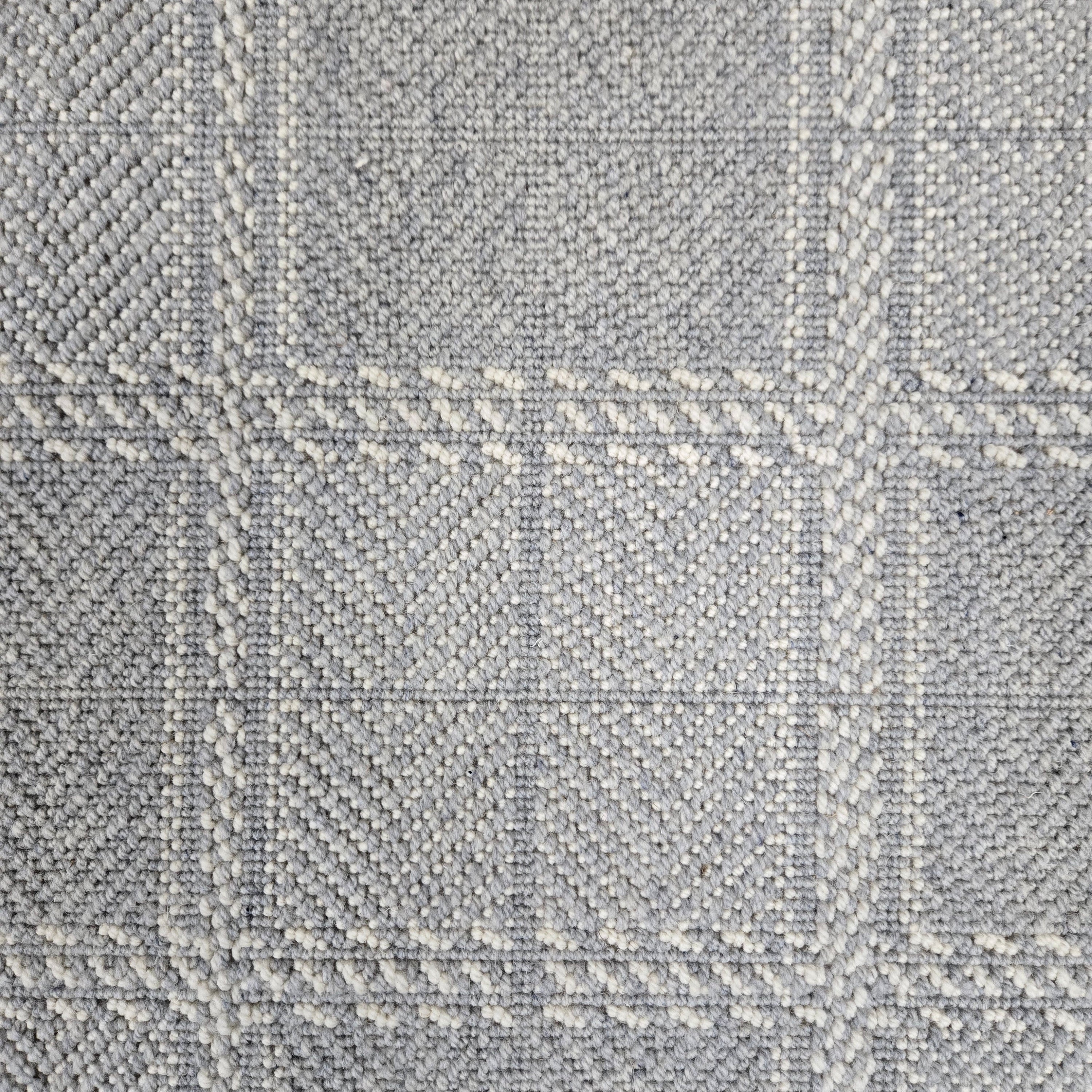 Broadloom carpet in wide box checkerboard pattern in cream and light blue.