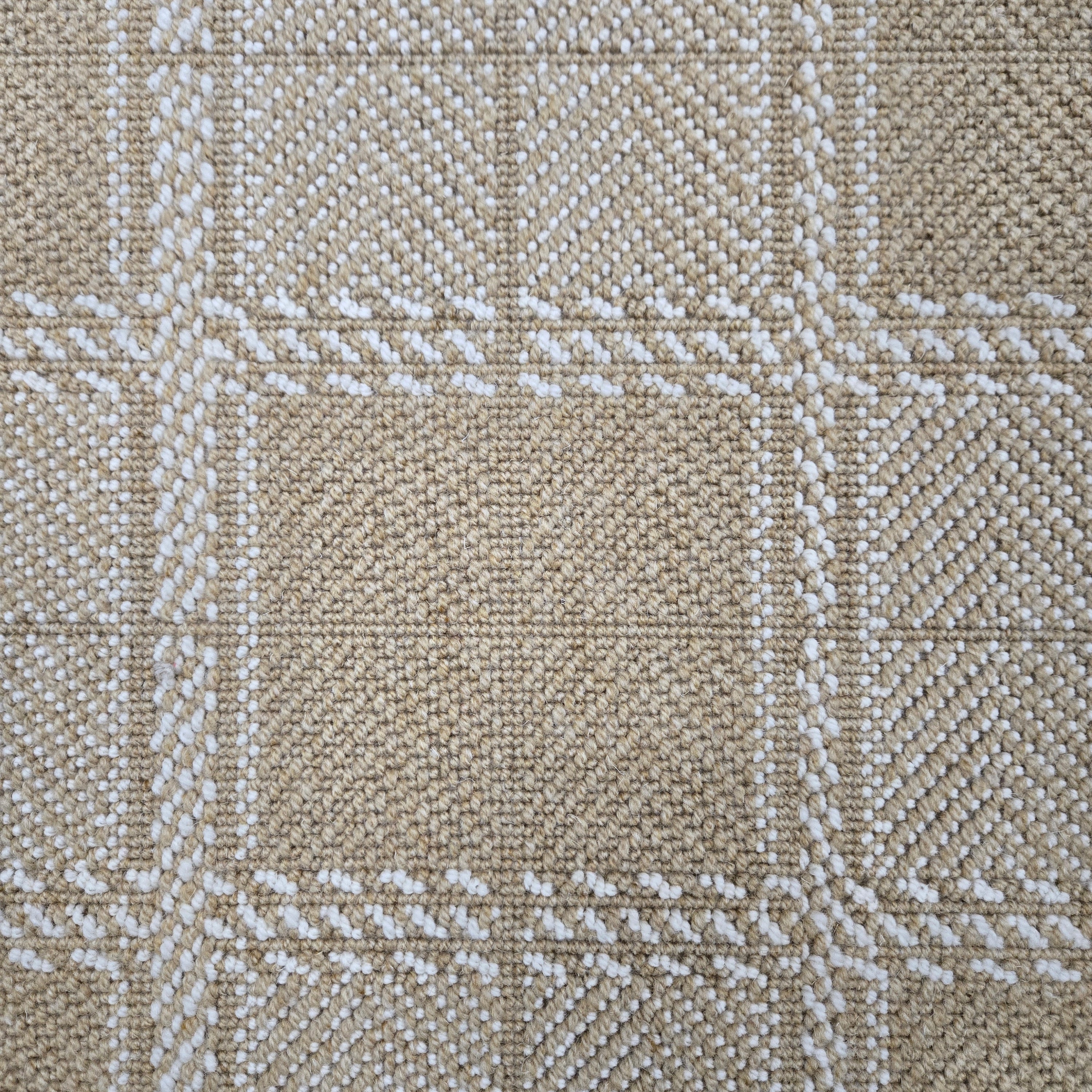 Broadloom carpet in wide box checkerboard pattern in tan and cream. 