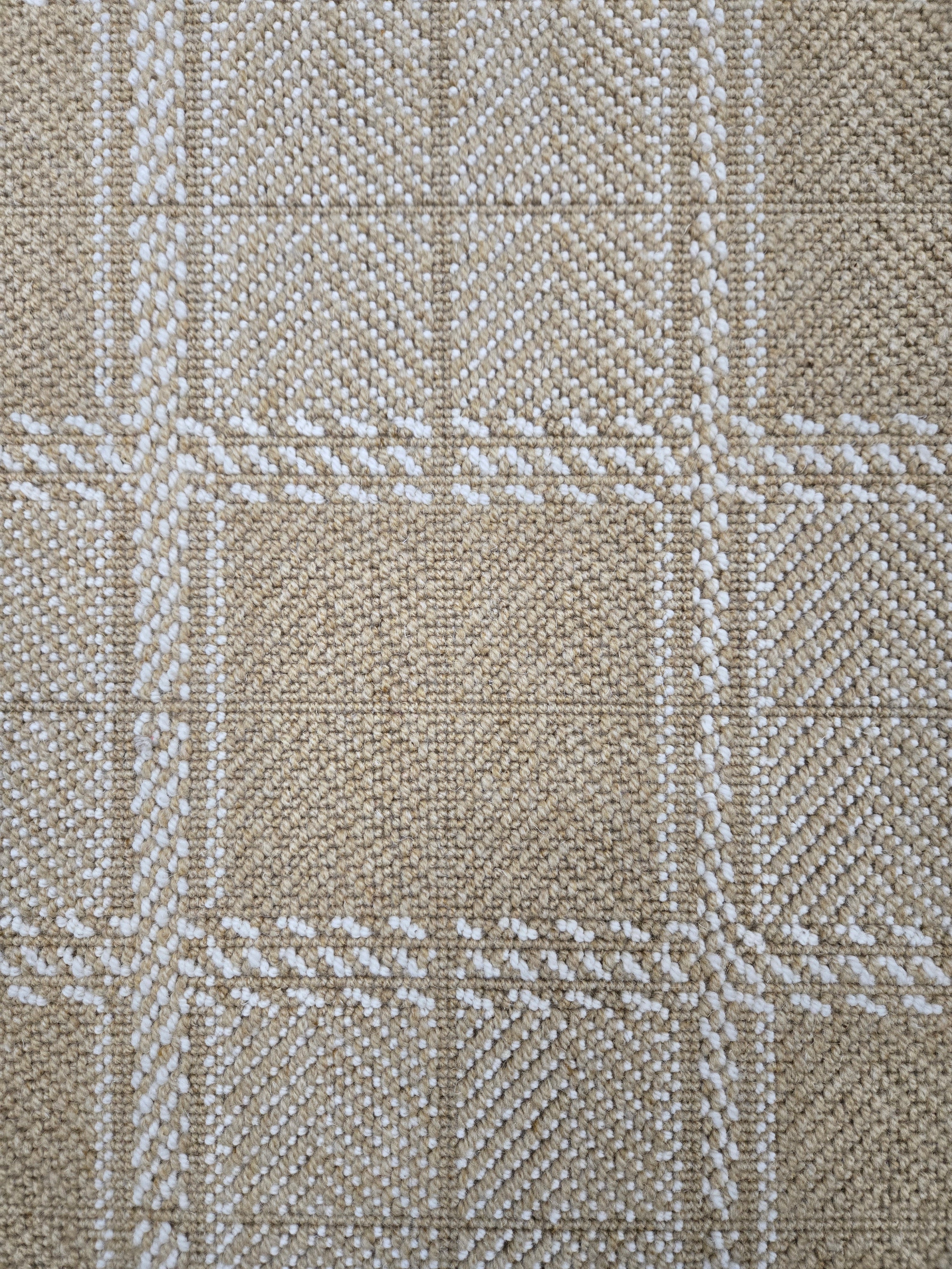 Broadloom carpet in wide box checkerboard pattern in tan and cream. 