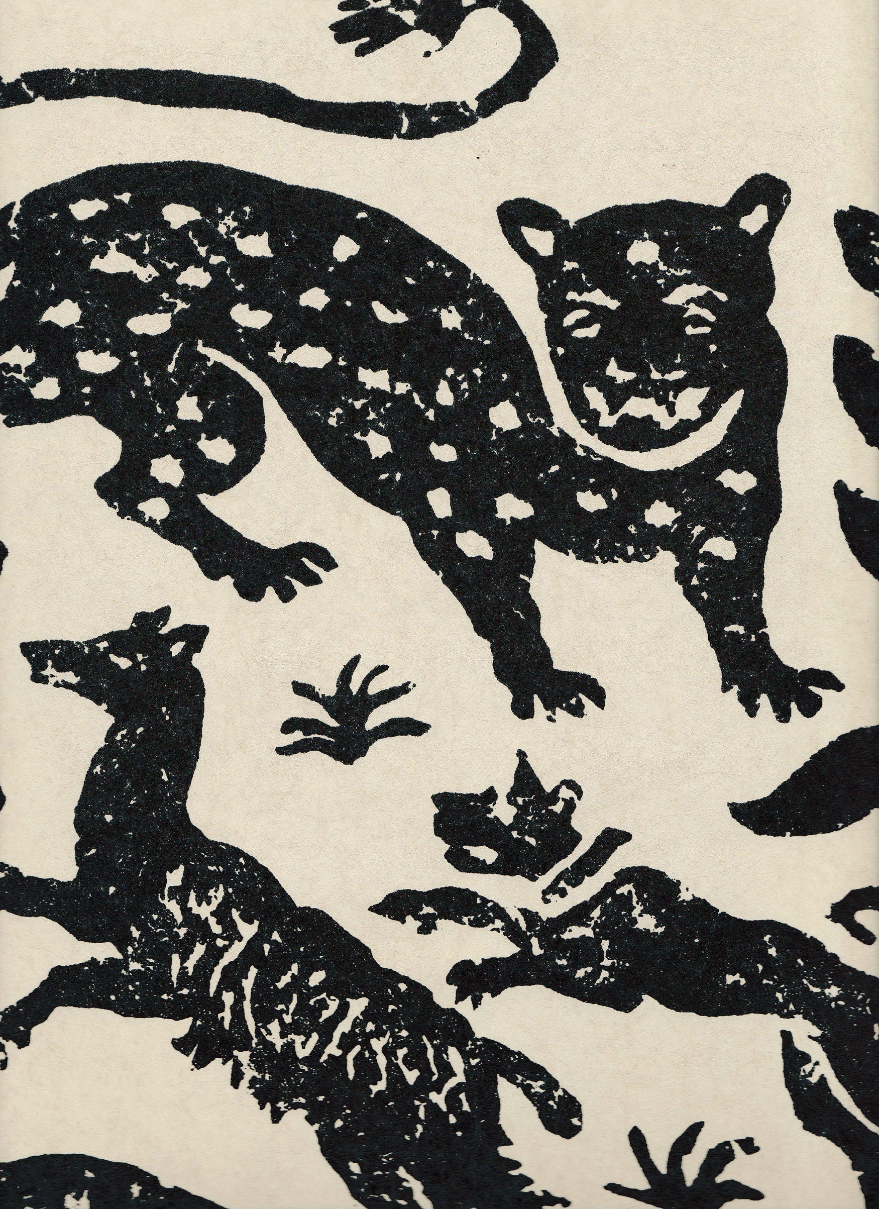 Detail of wallpaper in a playful animal print in black on a cream field.