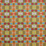 Close up of printed fabric with a complex geometric pattern with red, blue, orange and green. 