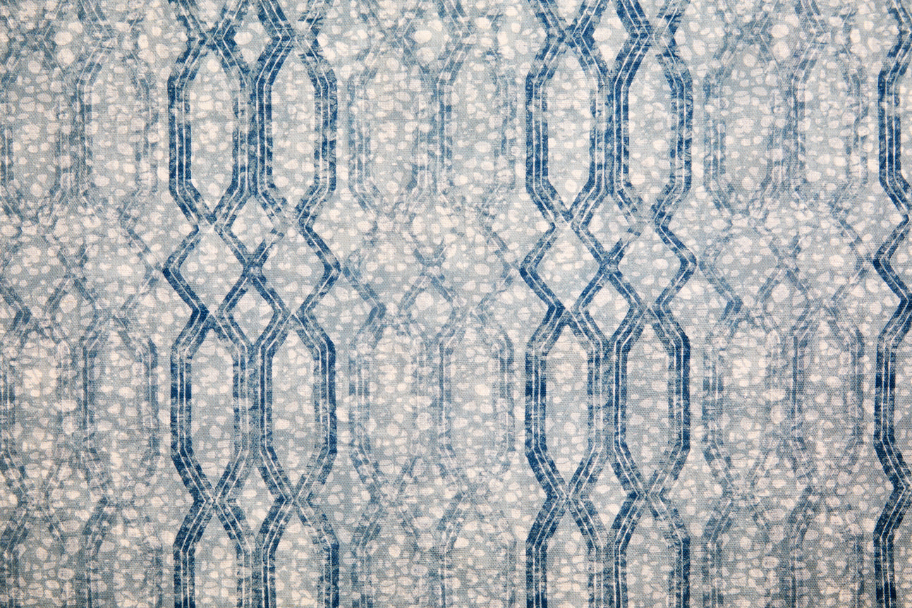 Printed fabric with monochomatic geometric stripe and mottled textural background in shades of blue. 