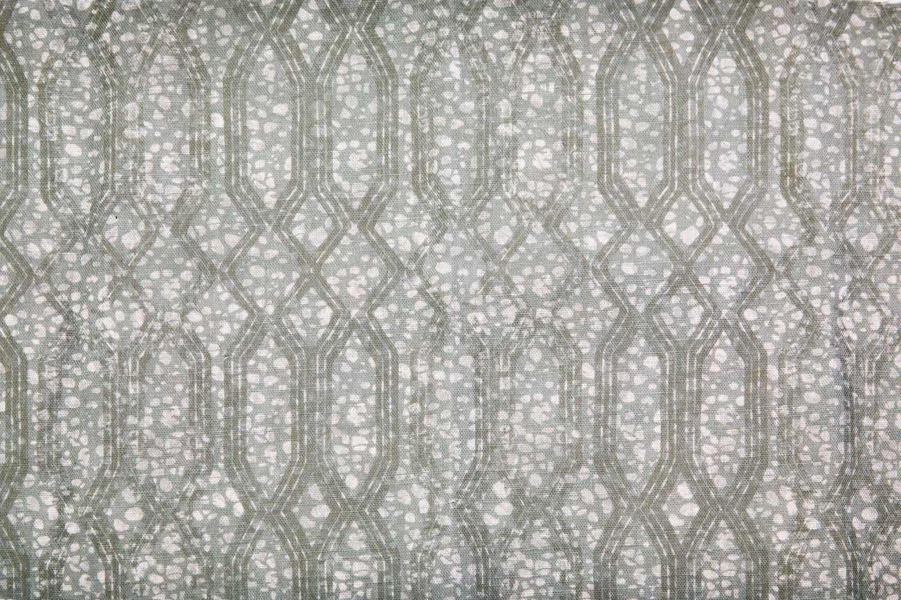 Printed fabric with monochomatic geometric stripe and mottled textural background in shades of grey. 