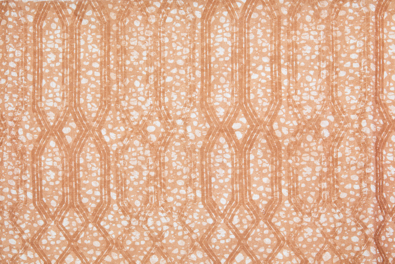 Printed fabric with monochomatic geometric stripe and mottled textural background in shades of orange.