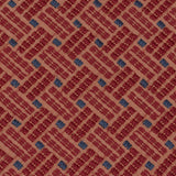 Detail of an embroidered fabric in a dashed basketweave design in red with blue accents.
