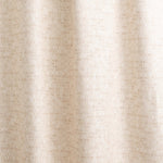 Draped fabric yardage in a textural geometric print in shades of cream on a white field.