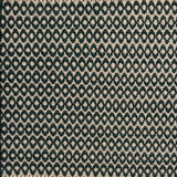 Handwoven wool rug with textural oval pattern in dark green on a beige field. 