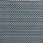 Handwoven wool rug with textural oval pattern in marine blue on a beige field. 