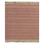 A woven rug sample with a blush pink and cream geometric oval pattern and fringed edges, shown flat against a white background.