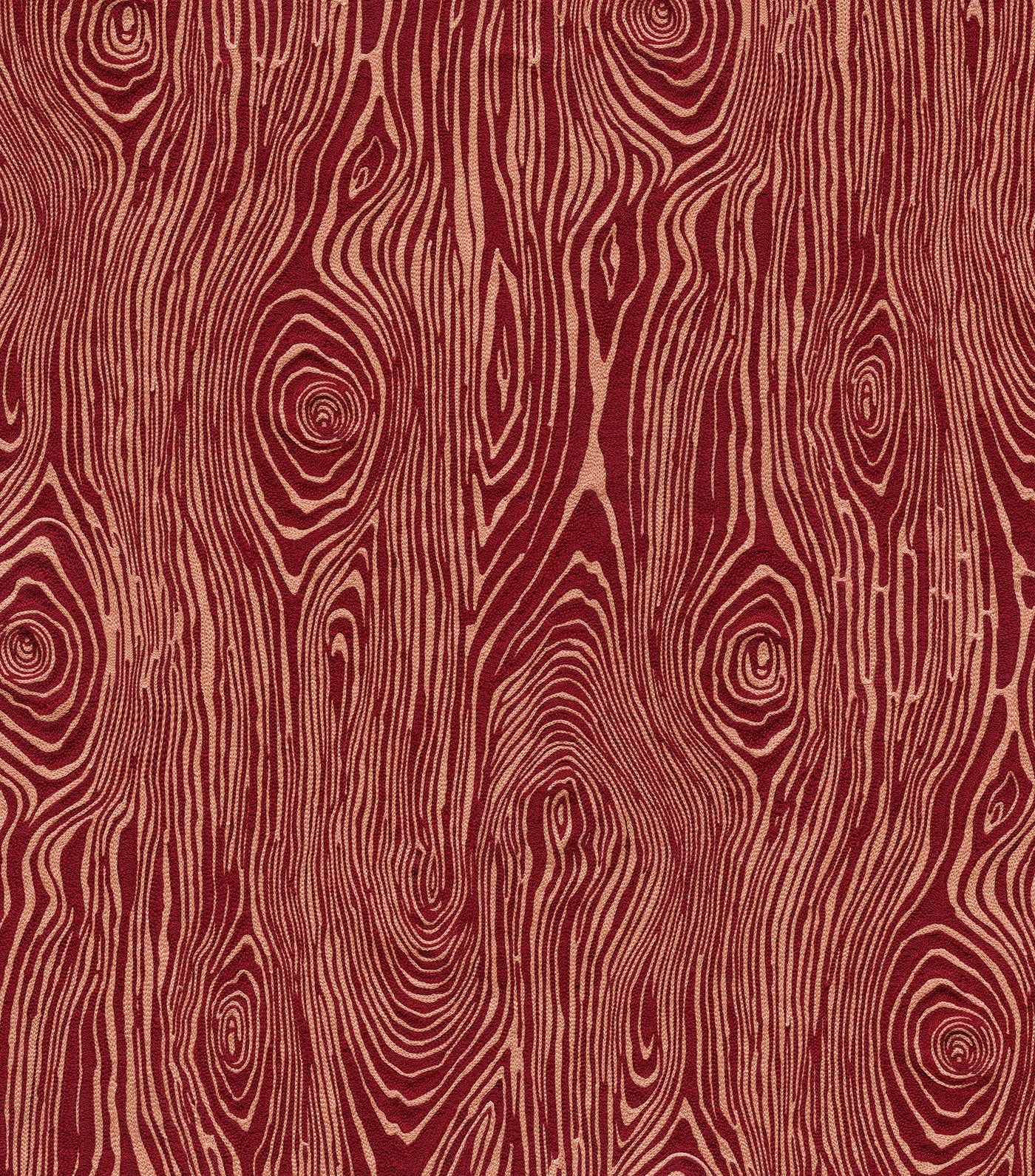 Detail of wallpaper in a textural wood grain print in coral on a red field.