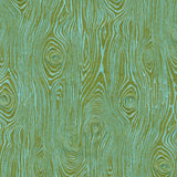 Detail of fabric in a textural wood grain print in green on a turquoise field.