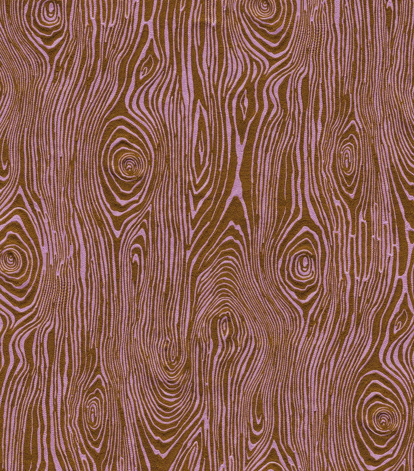Detail of wallpaper in a textural wood grain print in purple on a brown field.