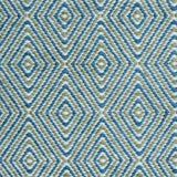 Handwoven rug in a geometric diamond pattern in blue, green and white. 