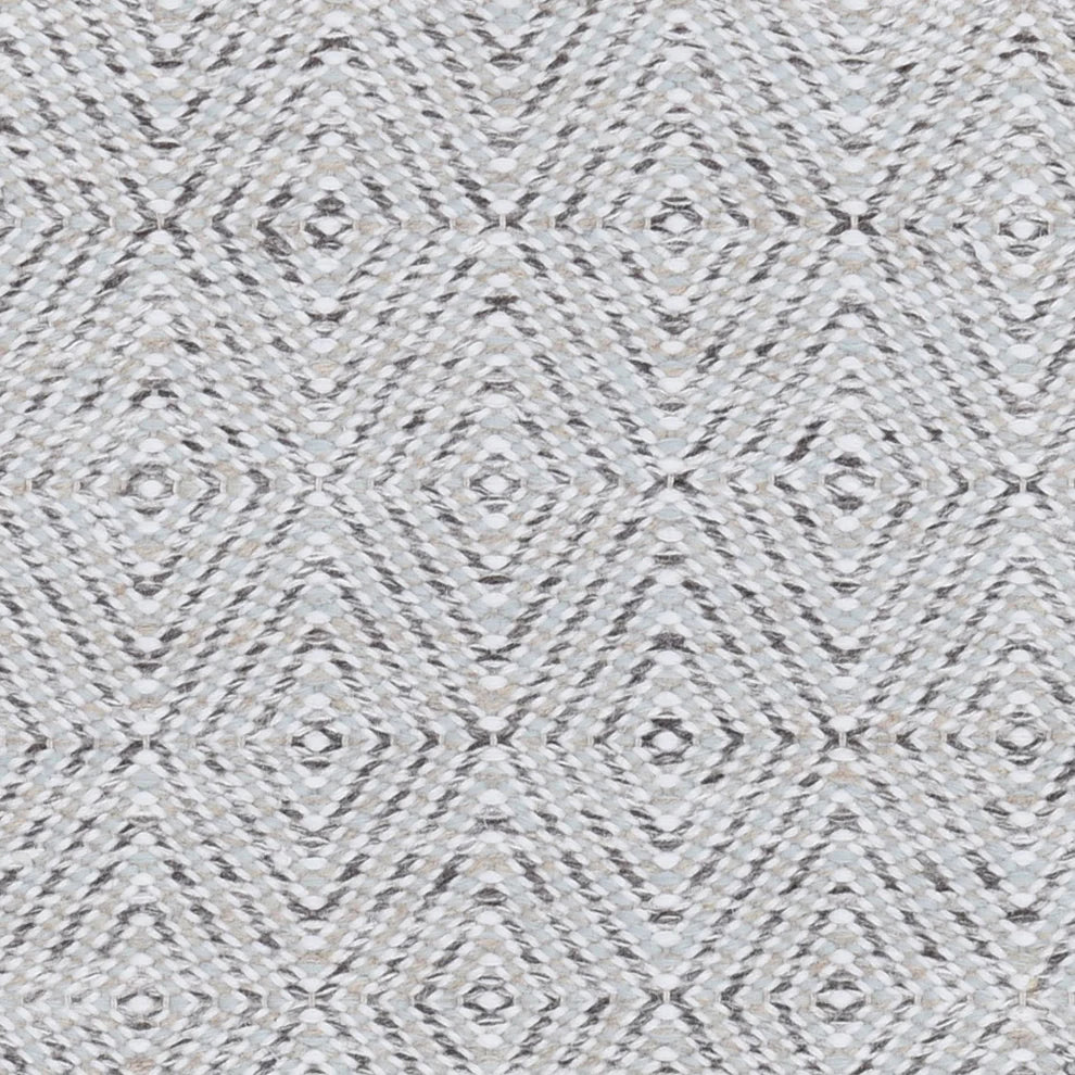 Handwoven rug in a geometric diamond pattern in white and grey. 