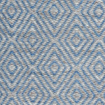 Handwoven rug in a geometric diamond pattern in blue and grey. 