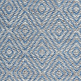 Handwoven rug in a geometric diamond pattern in blue and grey. 