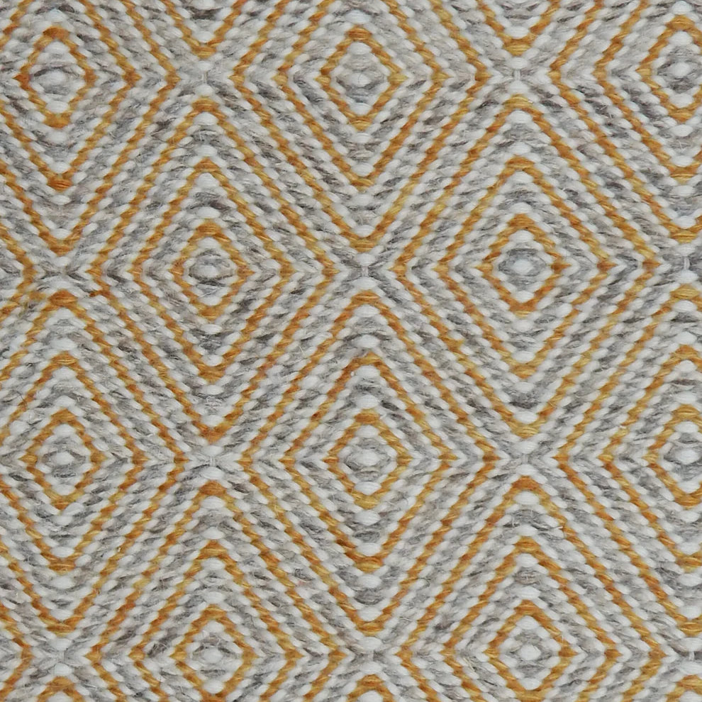 Handwoven rug in a geometric diamond pattern in grey, yellow and white. 