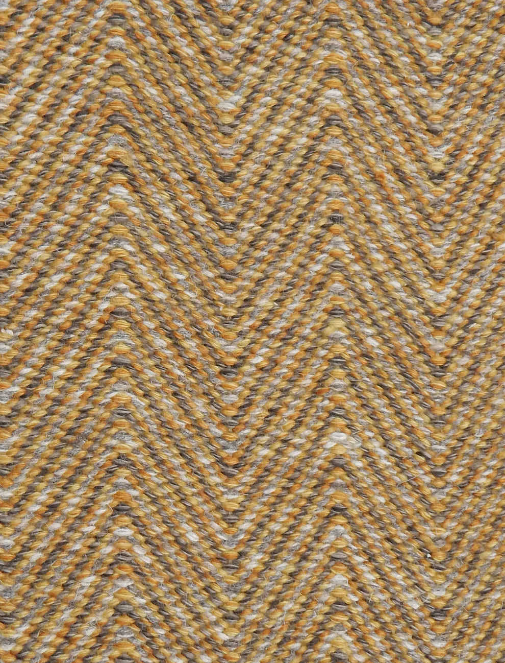 Handwoven rug in a herringbone pattern in grey and yellow