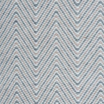 Handwoven rug in a herringbone pattern in pink, grey and white. 