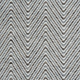 Handwoven rug in a herringbone pattern in shades of grey and white. 