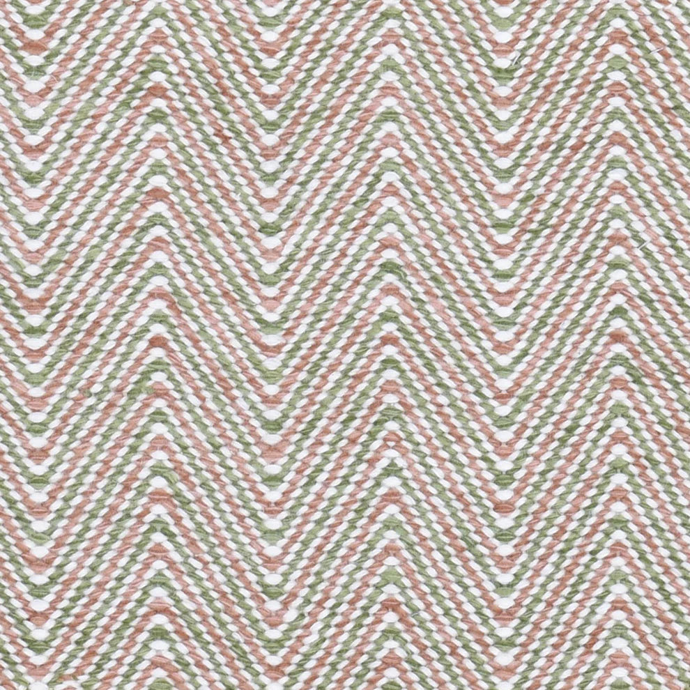 Handwoven rug in a herringbone pattern in pink, green and white. 