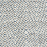 Handwoven rug in a herringbone pattern in blue, grey and white. 