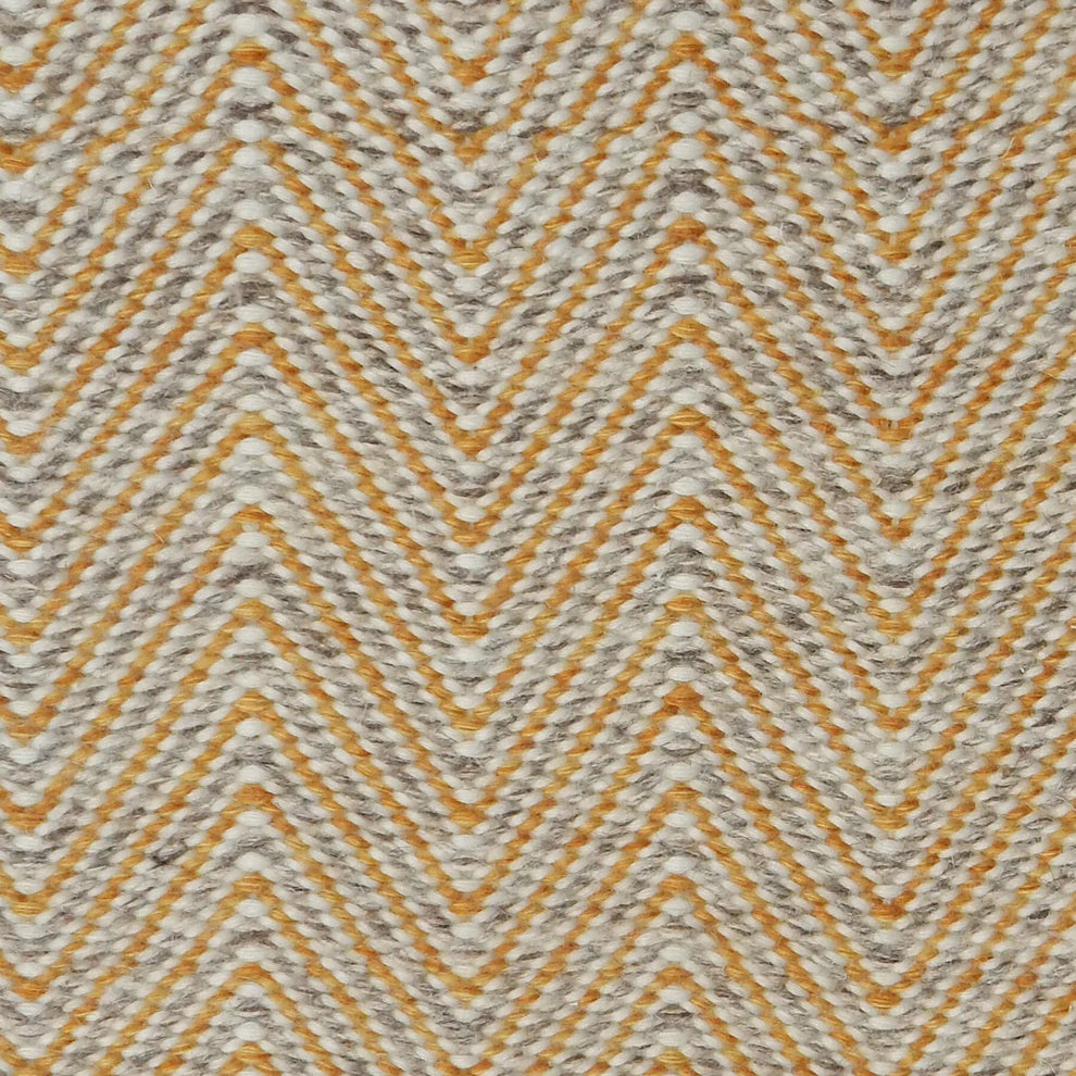 Handwoven rug in a herringbone pattern in yellow and grey. 