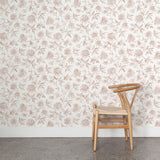 Wooden chair against a clay and white floral wallpapered wall