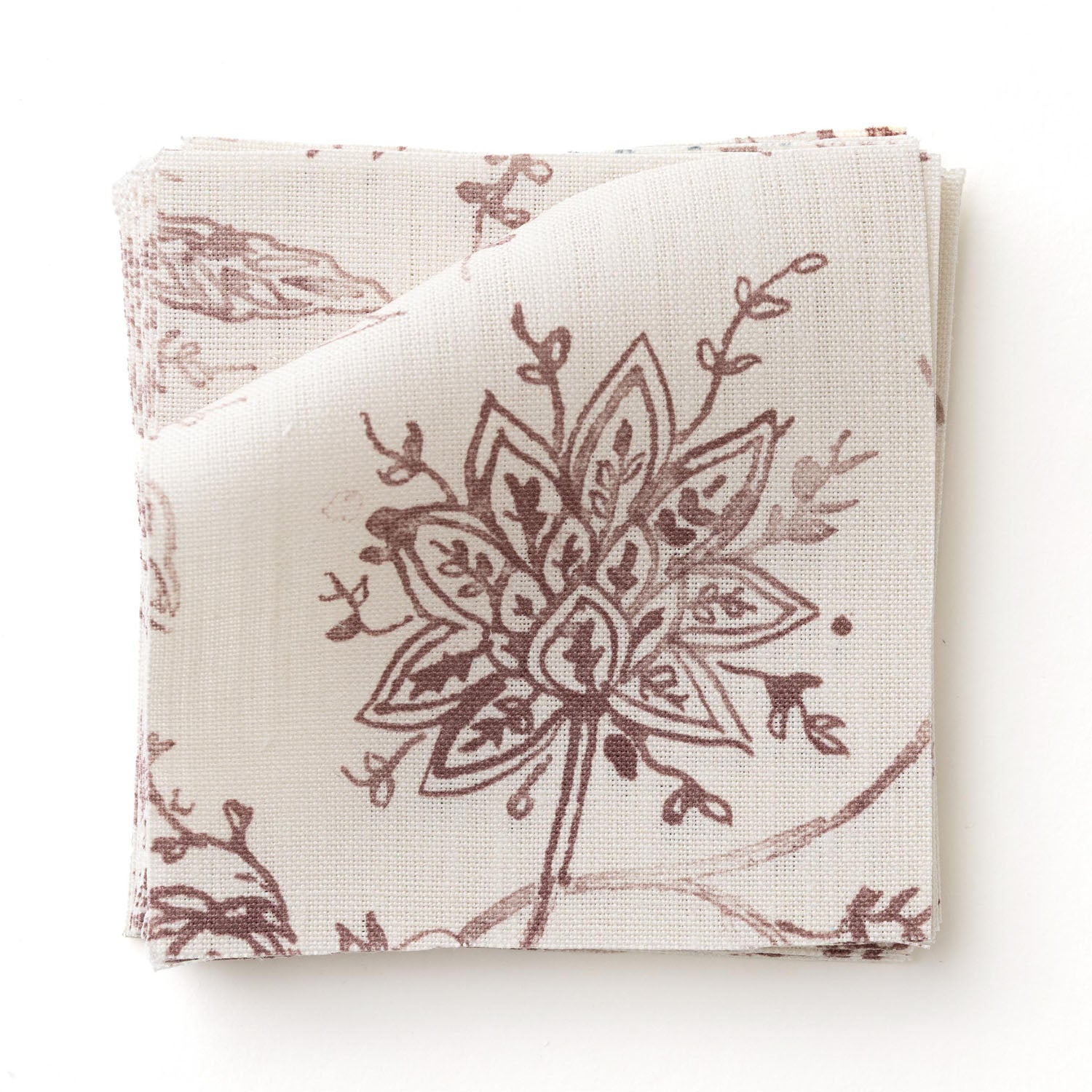 Fabric swatc with watercolor floral pattern with wine-purple leaves and flowers on a cream background