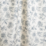 Draped fabric with watercolor floral pattern with ink blue leaves and flowers on a cream background