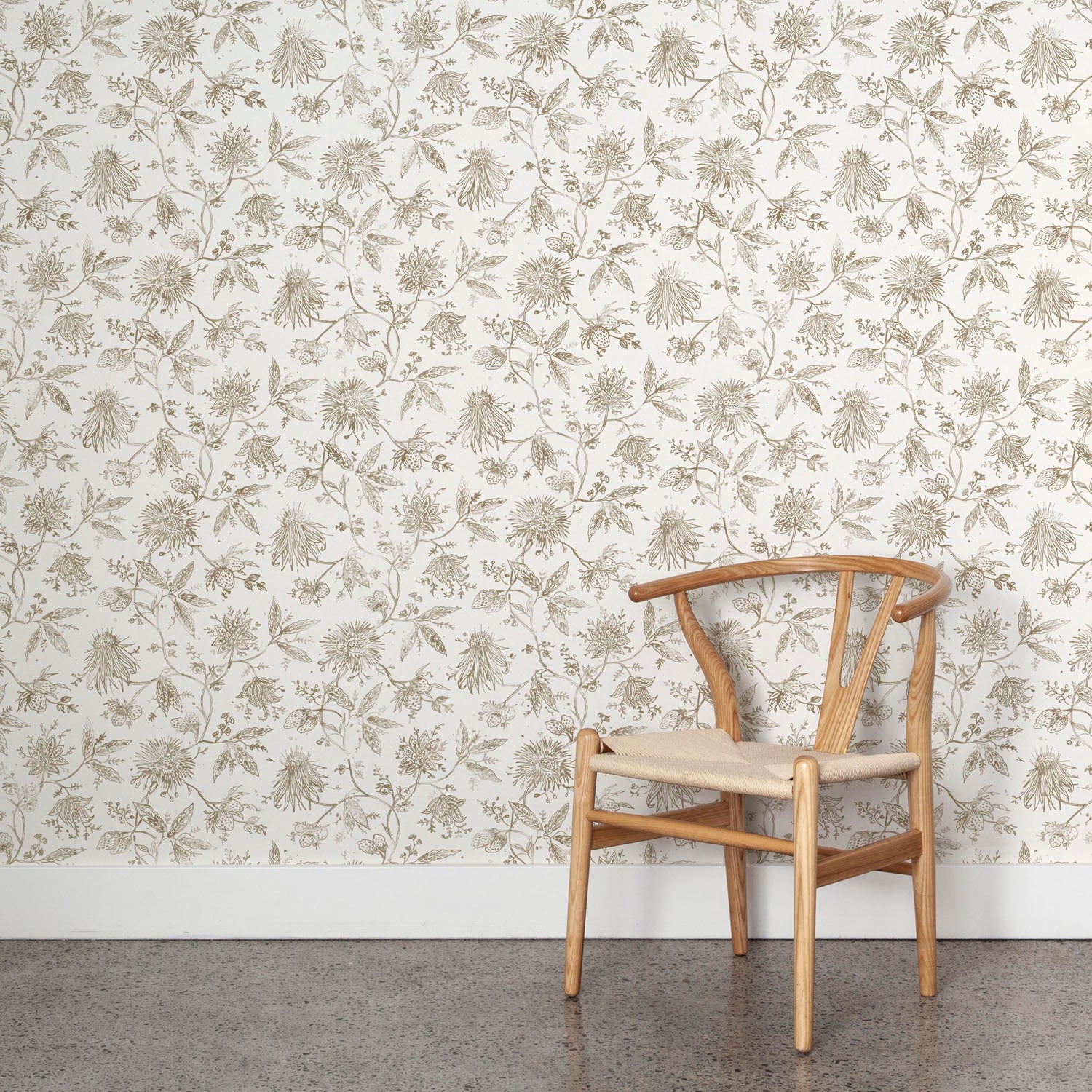 Wooden chair against a floral wallpapered wall