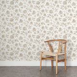 Wooden chair against a floral wallpapered wall