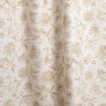 Draped fabric with watercolor floral pattern with tan leaves and flowers on a cream background