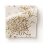 Fabric swatch with watercolor floral pattern with tan leaves and flowers on a cream background