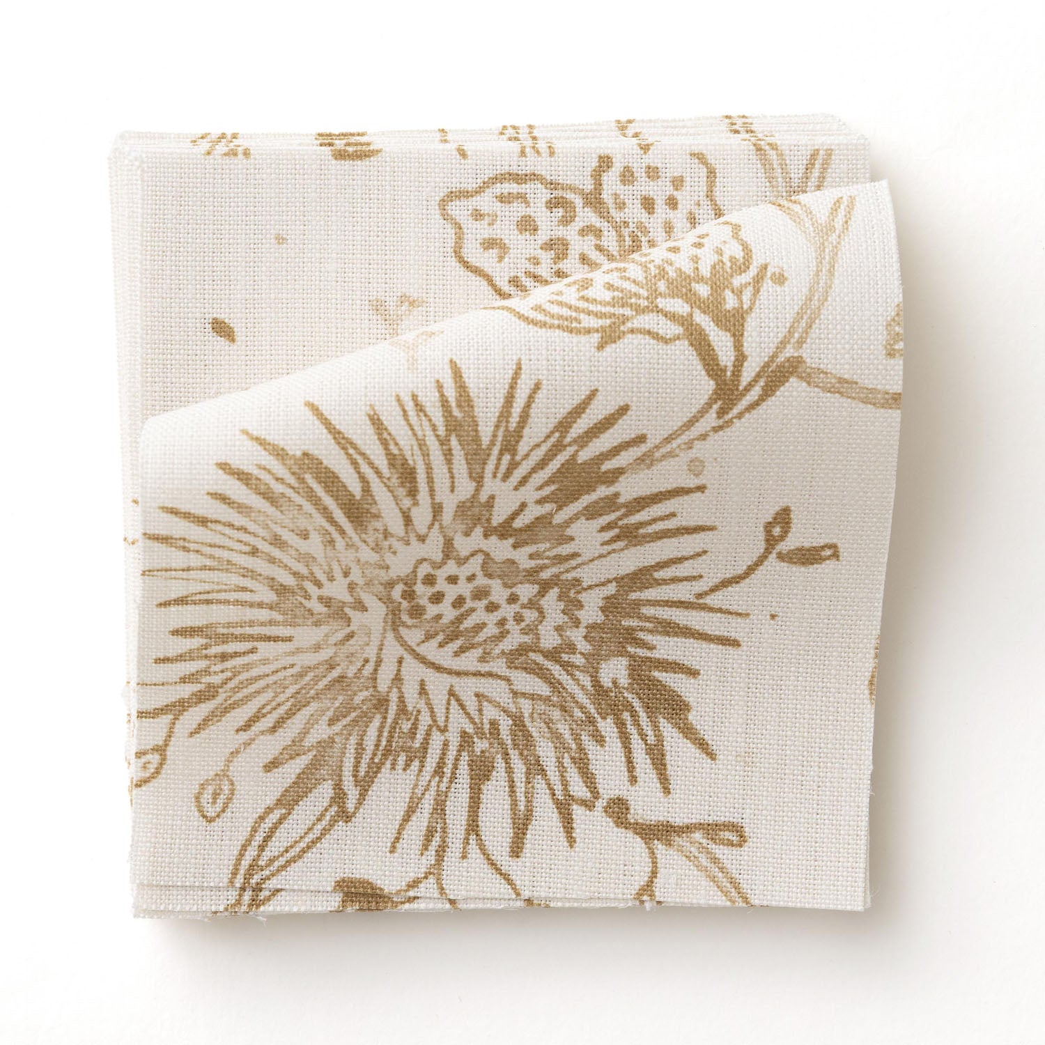 Fabric swatch with watercolor floral pattern with tan leaves and flowers on a cream background