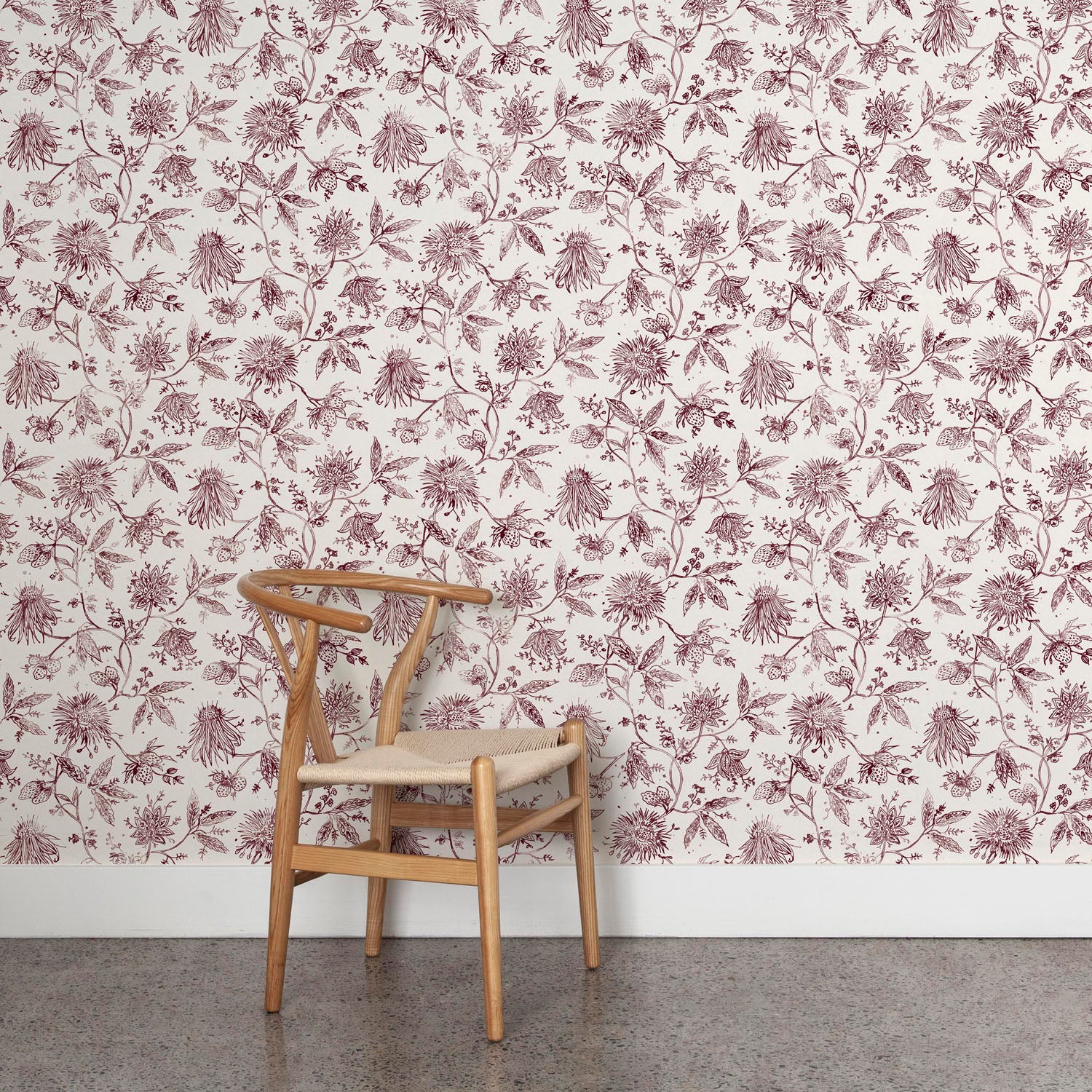Wooden chair against a purple and white floral wallpapered wall